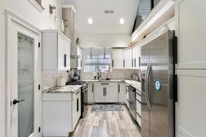 a kitchen with white cabinets and a stainless steel refrigerator at 212 E Toledo Ave in Wildwood Crest