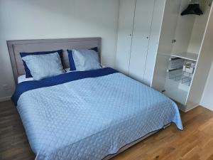 een slaapkamer met een bed met een blauw dekbed bij Fam house in Malling