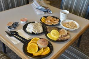 a table with different types of breakfast foods on it at The Madison Inn in Spokane