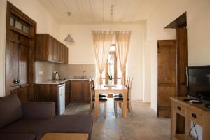 a kitchen with a table and chairs and a kitchen with a tablektop at Ktima 1937 Kannides in Droushia