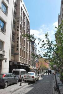 a city street with cars parked in front of a building at Hotel Inter Istanbul in Istanbul