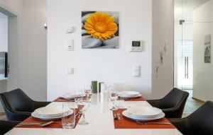 a dining room with a table and a flower on the wall at Ferienwohnung 90M² in Pörtschach am Wörthersee