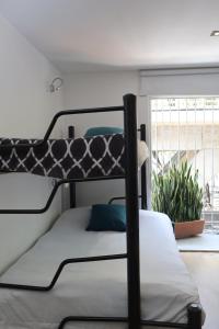 a bunk bed in a room with a window at Hermosa Habitación con balcon cama mat y litera Polanco in Mexico City