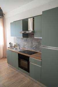 a kitchen with a sink and a refrigerator at Viroga Suite Apartments in Castel Volturno