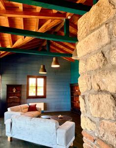a living room with a couch and a stone wall at Hotel & Villas - TERIZIS Le Rocher in Bŭlgarevo +171 photos