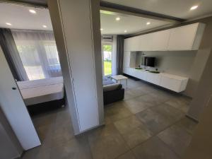 a large living room with a couch and a tv at Apartamenty Kacper Grzybowo in Grzybowo