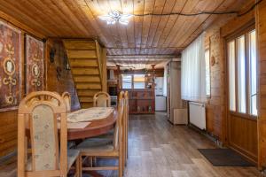 a kitchen and dining room with a table and chairs at Cabana Viilor Dej in Dej