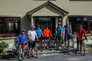 a group of people standing in front of a house with their bikes at The Country Haven Aircode V31Y166 in Ballybunion