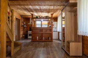a kitchen with wooden floors and a wooden ceiling at Cabana Viilor Dej in Dej +13 photos