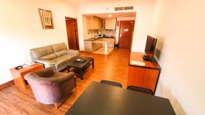 a living room with a couch and a table at Parkview Hotel in Kampong Jerudong