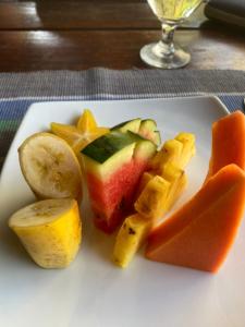 a plate of fruit and vegetables on a table at New Palms Villa Induruwa Homestay in Induruwa
