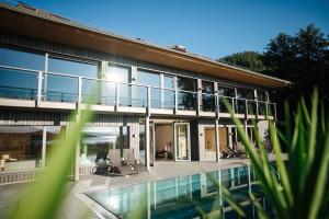 a house with a swimming pool in front of it at Seensucht Klopeinersee in Sankt Kanzian