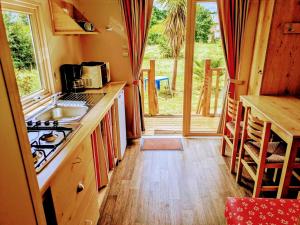 a kitchen with a sink and a stove top oven at Domaine de Launay blot in Baguer-Morvan