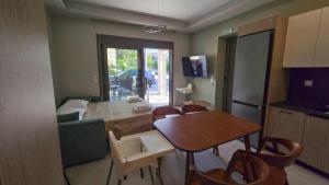 a living room with a table and a dining room at SeaNest Luxury Accomodation Hanioti in Hanioti
