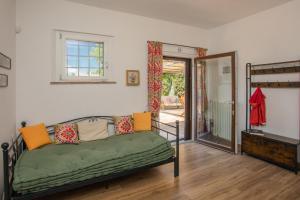 a living room with a couch and a sliding glass door at LA COLLINA DEGLI ULIVI 8&2, Emma Villas in Montefalco