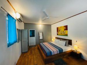 a bedroom with a bed in a room at Vibration Nilaveli in Trincomalee