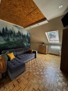 a living room with a couch and a painting on the wall at Willa Krynica in Krynica Zdrój +70 photos