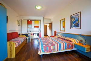 a bedroom with a bed and a couch at Residenz Moncucco in Luino +6 photos
