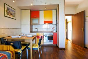 a kitchen with a table and chairs and a dining room at Residenz Moncucco in Luino