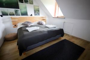 a bedroom with a bed with two pillows on it at BILÍKOVA CHATA - Horský hotel in Smokovce