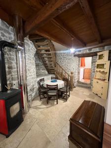 a living room with a table and a stove at Apartman Poli Luce in Gračišće