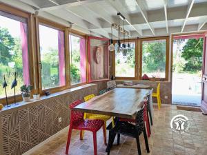 a dining room with a wooden table and chairs at Les Petites Fontenelles in Montjean