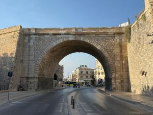 a stone bridge over a street with a road at Chanioporta suites in Heraklio +20 photos