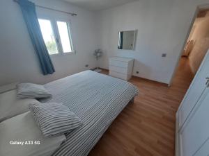 Łóżko lub łóżka w pokoju w obiekcie Bonito apartamento reformado en Las Coronas
