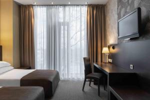 Vuode tai vuoteita majoituspaikassa Rixwell Elefant Hotel
