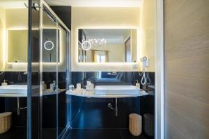 a bathroom with two sinks and a mirror at Duomo Suites Florence in Florence
