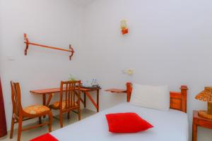 a bedroom with a bed and a table and chairs at Castle Resort Yala in Tissamaharama +46 photos