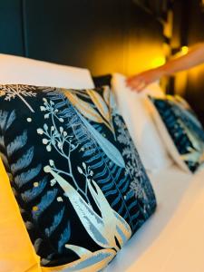 two ties sitting on top of a bed at La Suite Saint Roch in Villeréal