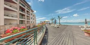 a boardwalk leading to the beach at a resort at Marina City ApartHotel in Balchik