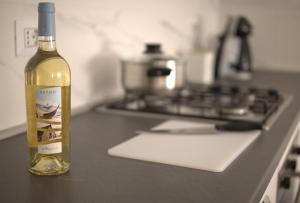 a bottle of wine sitting on a counter next to a stove at Domus Gianni in Assemini +9 photos
