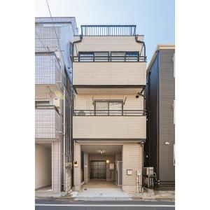 an external view of a building with a garage at Tokyo Stay House Hirai in Tokyo