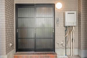 a door with a cell phone on the side of a building at Tokyo Stay House Hirai in Tokyo +77 photos