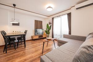 a living room with a couch and a table at Tokyo Stay House Hirai in Tokyo