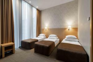 Vuode tai vuoteita majoituspaikassa Rixwell Elefant Hotel