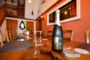 a bottle of wine sitting on top of a table at Gîte Oncle Yerry Ostheim in Ostheim