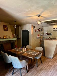 a dining room with a wooden table and chairs at Quattro Malyovitsa- Мальовица in Govedartsi