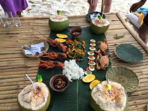 a table with seafood and other food on it at Prince John Beachfront Eco Bungalows and Restaurant in San Vicente