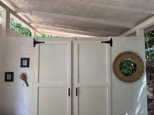 a white garage door with a wreath on it at Alunis GLAMPING in Aluniş +26 photos