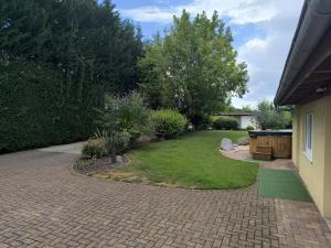 a garden with a brick walkway and a lawn at Gite oncle Yerry in Ostheim