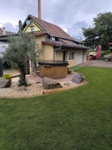 a house with a hot tub in a yard at Gite oncle Yerry in Ostheim