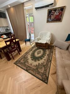 a living room with a couch and a rug at gaydi in Gori