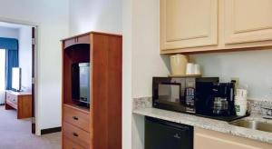 a kitchen with a sink and a microwave at Quality Inn & Suites Airport in Austin