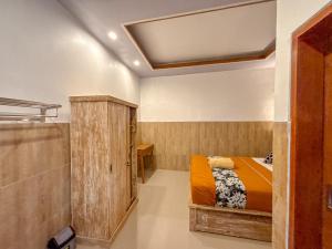a bedroom with a bed and a shower in it at Vins Family Homestay in Tumbak Bayuh