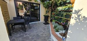 a patio with a table and some potted plants at Derosas House in Golfo Aranci
