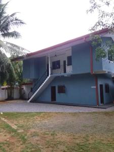 a blue and white building with a staircase on it at LAKROinn in Matugama