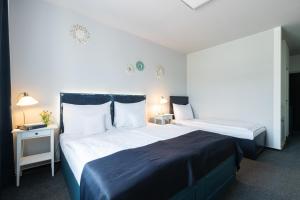 Postel nebo postele na pokoji v ubytování Hotel Maroli Mikulov